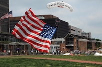 Skydivers carrying U.S. flags parachute into Independence Mall June 14 during the Stripes and Stars Festival celebrating the U.S. Army 242nd birthday at Independence Hall in Philadelphia.