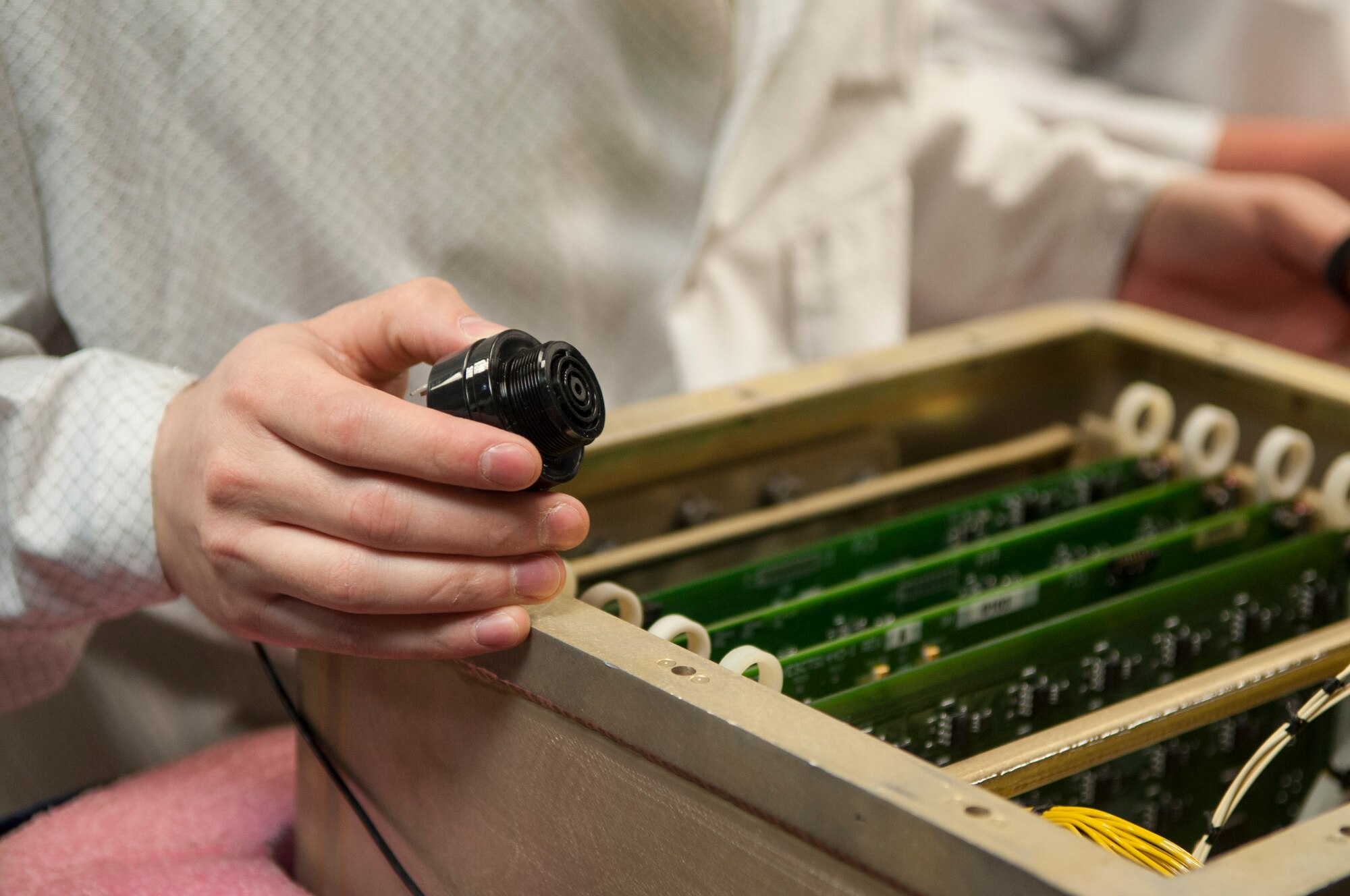 A member of the 791st Maintenance Squadron Global Strike Challenge electronics laboratory team removes an alarm at Minot Air Force Base, N.D., May 31, 2017. The ELAB team practiced maintenance on a circuitry test set in preparation for Global Strike Challenge 2017. (U.S. Air Force photo/Airman 1st Class Jonathan McElderry)