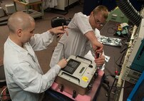 (From left) Staff Sgt. Dustin Stetler and Tech. Sgt. Maxie Cardinal, 791st Maintenance Squadron electronics laboratory technicians, assemble a circuitry test set at Minot Air Force Base, N.D., May 31, 2017. During training, the maintenance team inspected and tested various components of a circuitry test set to prepare for Global Strike Challenge 2017. (U.S. Air Force photo/Airman 1st Class Jonathan McElderry)