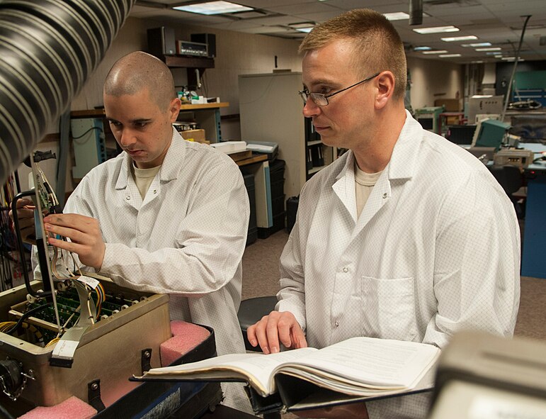 (From left) Staff Sgt. Dustin Stetler and Tech. Sgt. Maxie Cardinal, 791st Maintenance Squadron electronics laboratory technicians, inspect a circuitry test set at Minot Air Force Base, N.D., May 31, 2017. The ELAB team performed maintenance on a circuitry test set to help them prepare for Global Strike Challenge 2017. (U.S. Air Force photo/Airman 1st Class Jonathan McElderry)