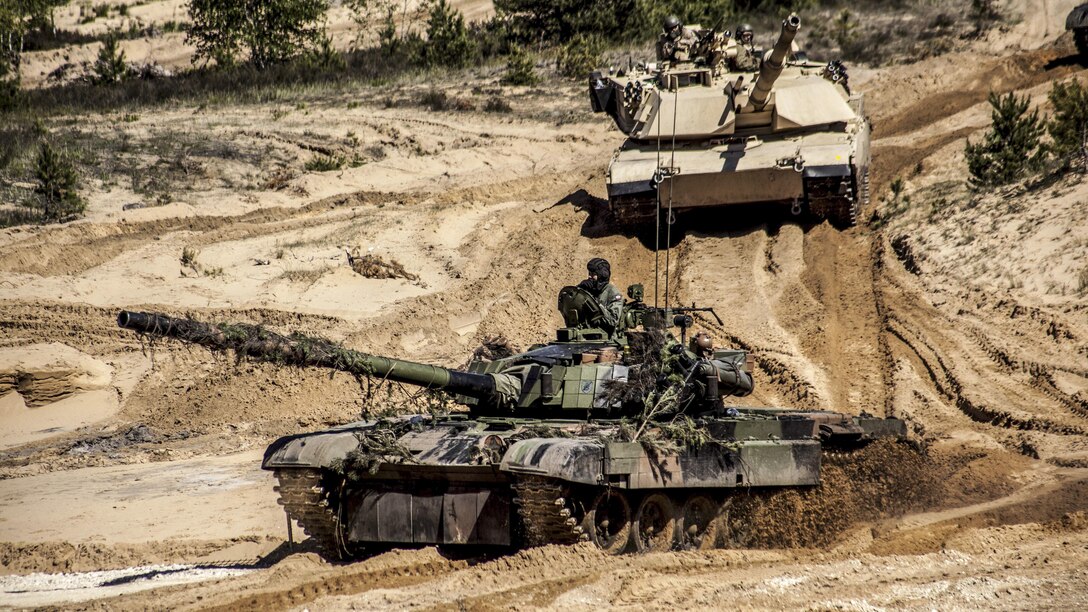 Polish soldiers and U.S. Marines operate tanks during a combined arms live-fire training event at the Adazi training grounds in Latvia, June 9, 2017, as part of Saber Strike, an annual exercise in the Baltic region and Poland. Marine Corps photo by 1st Lt. Kristine Racicot