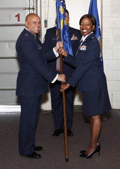 Col. Frank Verdugo, 90th Mission Support Group commander, passes the guidon to Lt. Col. Erin O. Weatherly, 90th Civil Engineer Squadron commander, during the 90th CES change-of-command ceremony June 15, 2017, as Master Sgt. Jeremy Britten, 90th CES first sergeant, stands in the background in the Tech Sgt. Matthew Schwartz Explosive Ordnance Disposal Facility on F.E. Warren Air Force Base, Wyo. The ceremony signified the transition of command from Lt. Col Robert C. Lance to Weatherly.  (U.S. Air Force photo by Lan Kim)