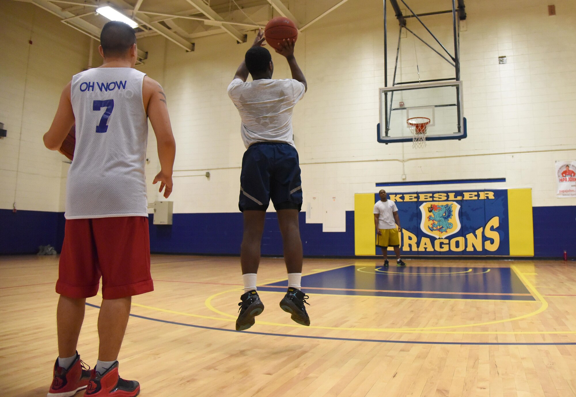 Airman 1st Class Emante Jackson, 81st Surgical Operations Squadron surgical technician, shoots a basketball as 2nd Lt. Johnny Inlavon, 333rd Training Squadron student, waits for his turn during a basketball knockout competition in the Blake Fitness Center June 12, 2017, on Keesler Air Force Base, Miss. The competition was one of several Wingman Week events focusing on resiliency and teambuilding initiatives across the base. (U.S. Air Force photo by Kemberly Groue)
