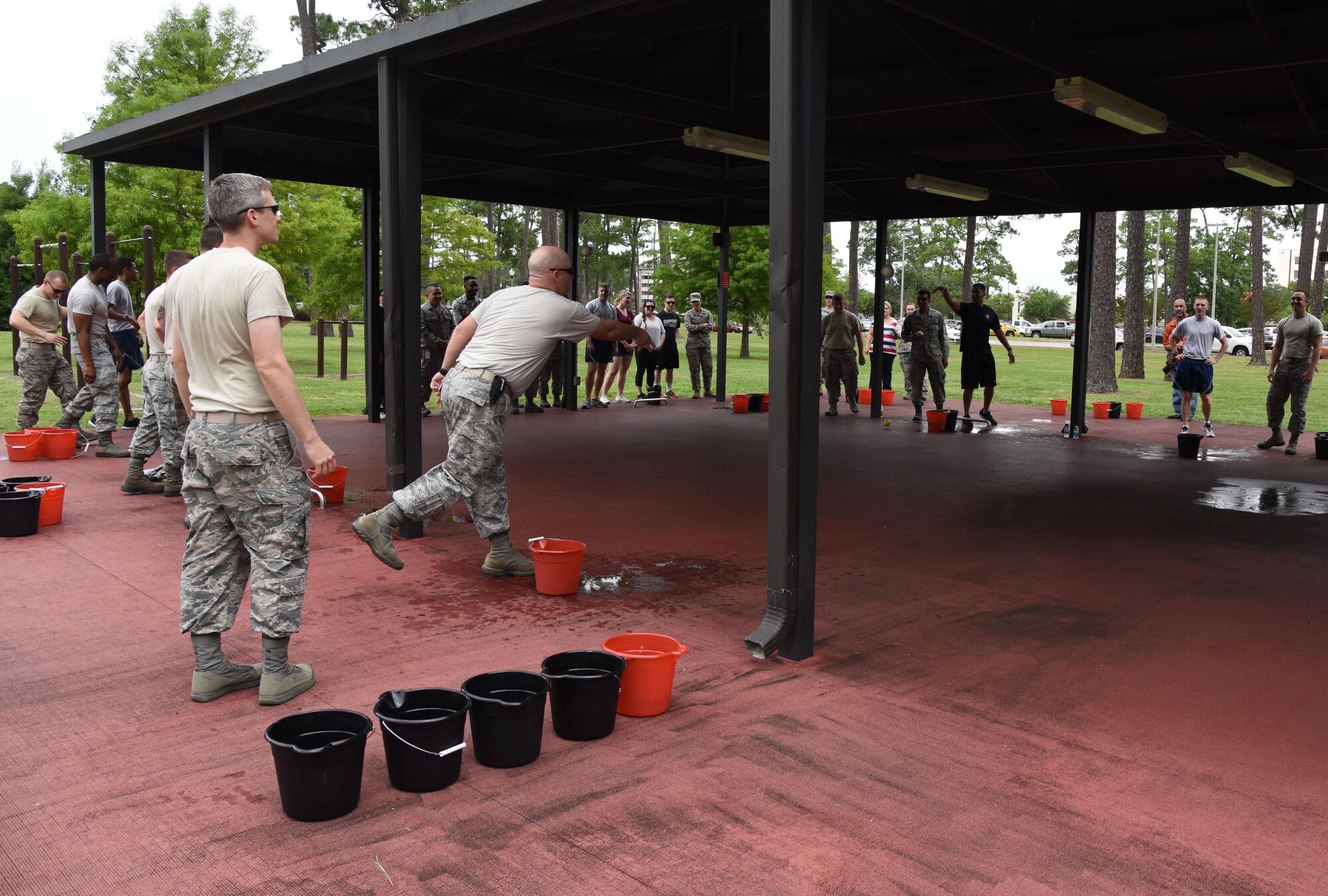 Keesler personnel participate in a bucket pong competition at the Crotwell Track June 12, 2017, on Keesler Air Force Base, Miss. The competition was one of several Wingman Week events focusing on resiliency and teambuilding initiatives across the base. (U.S. Air Force photo by Kemberly Groue)