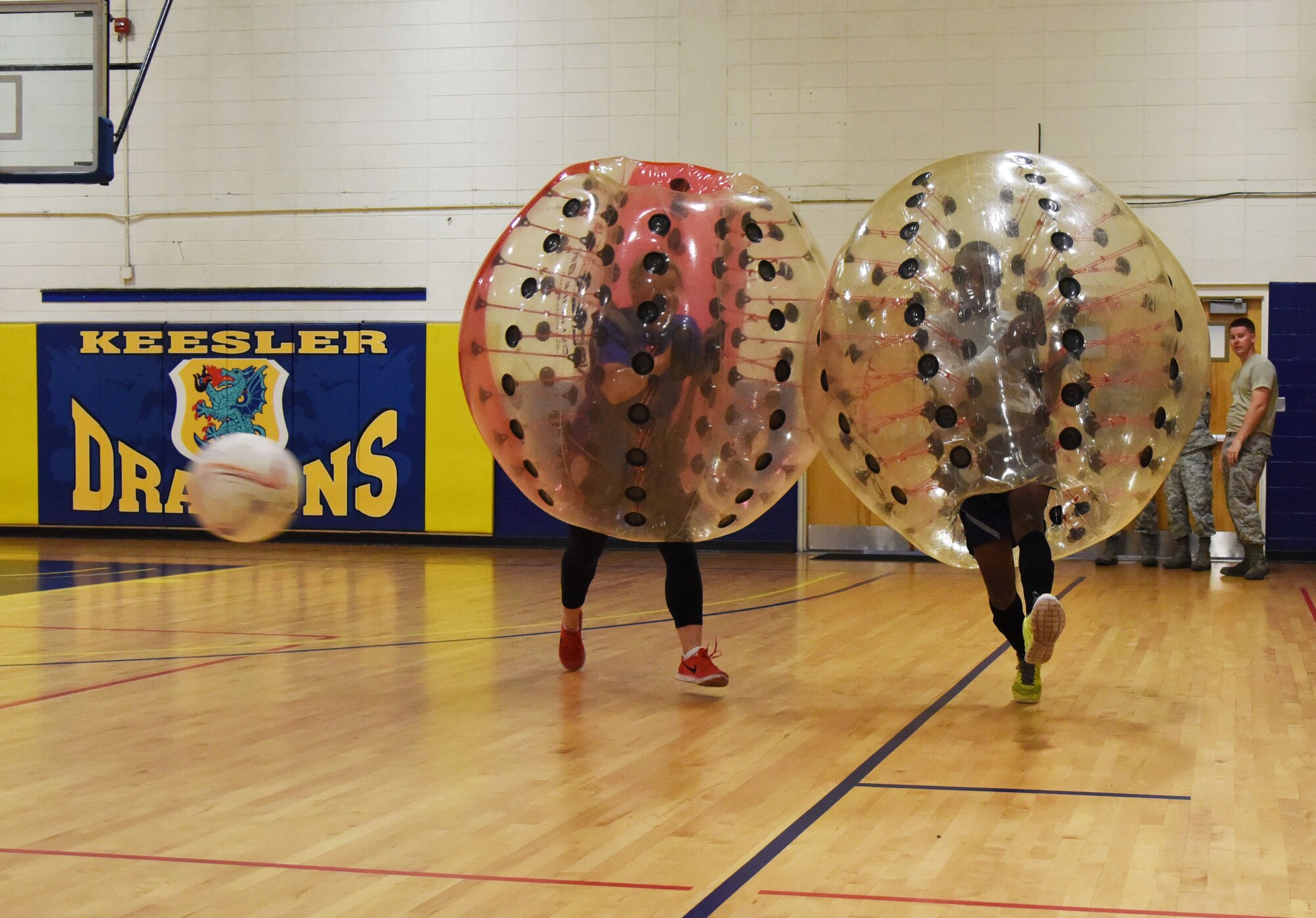 First Lt. Ashton Ross, 81st Training Wing sexual assault and response center deputy, chases Airman 1st Class Samuel Adedeji, 81st Medical Support Squadron medical logistics technician, as he kicks a soccer ball during a bubble soccer competition in the Blake Fitness Center June 12, 2017, on Keesler Air Force Base, Miss. The competition was one of several Wingman Week events focusing on resiliency and teambuilding initiatives across the base. (U.S. Air Force photo by Kemberly Groue)
