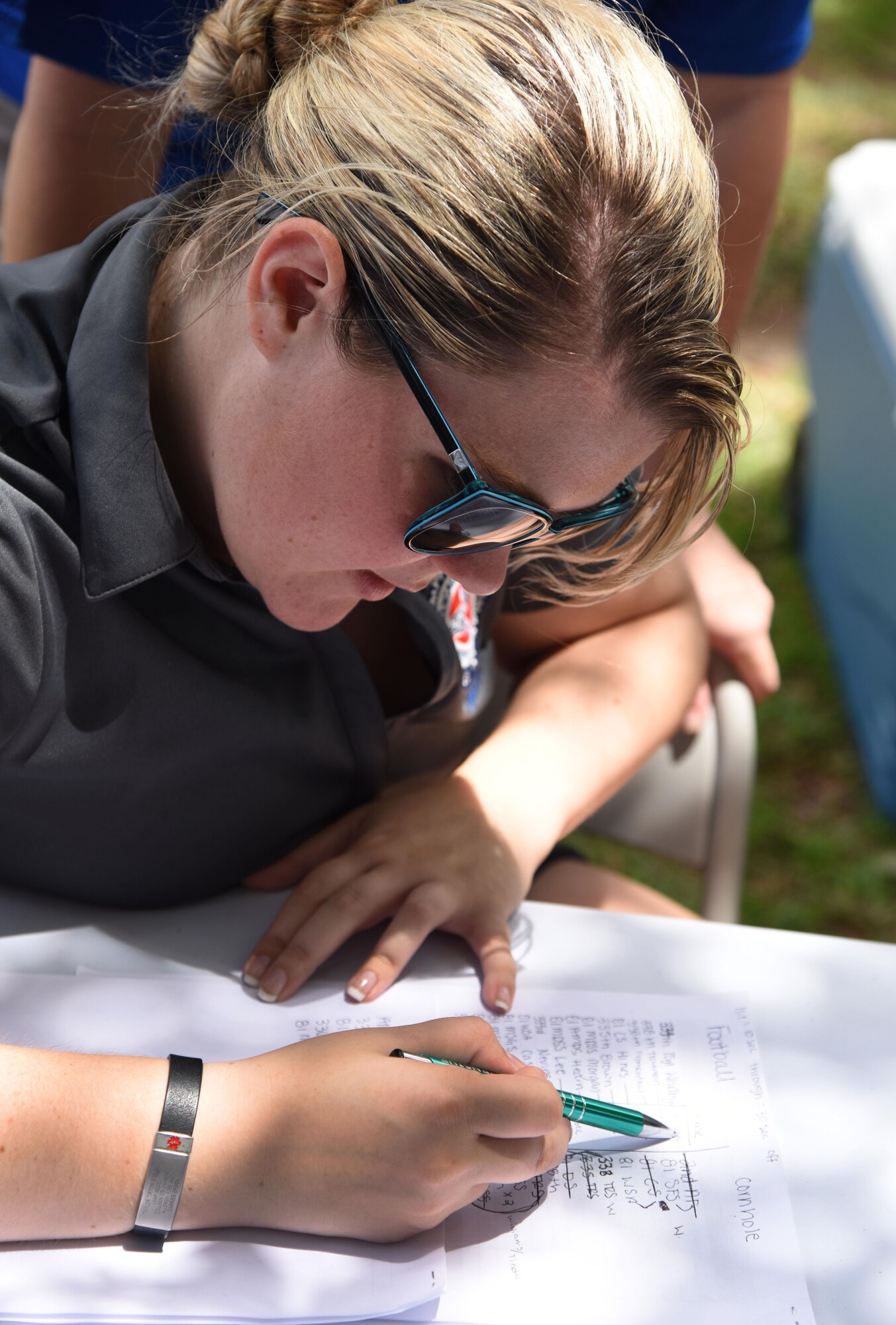 Senior Airman Taylor Tipten, 81st Aerospace Medicine Squadron BOMB-C technician, tallies the scores for a football skills competition behind the Blake Fitness Center June 13, 2017, on Keesler Air Force Base, Miss. The competition was one of several Wingman Week events focusing on resiliency and teambuilding initiatives across the base. (U.S. Air Force photo by Kemberly Groue)