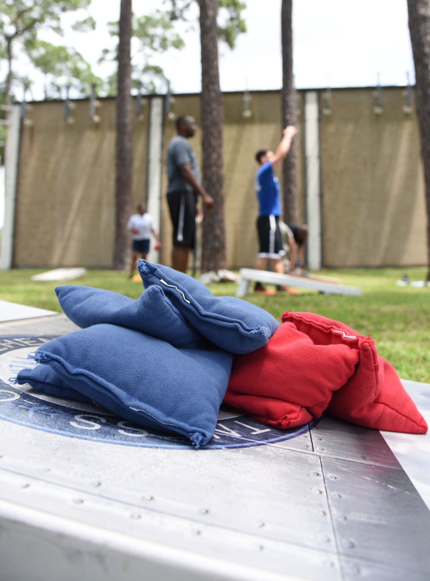 Keesler Airmen participate in a cornhole competition behind the Blake Fitness Center June 13, 2017, on Keesler Air Force Base, Miss. The competition was one of several Wingman Week events focusing on resiliency and teambuilding initiatives across the base. (U.S. Air Force photo by Kemberly Groue)