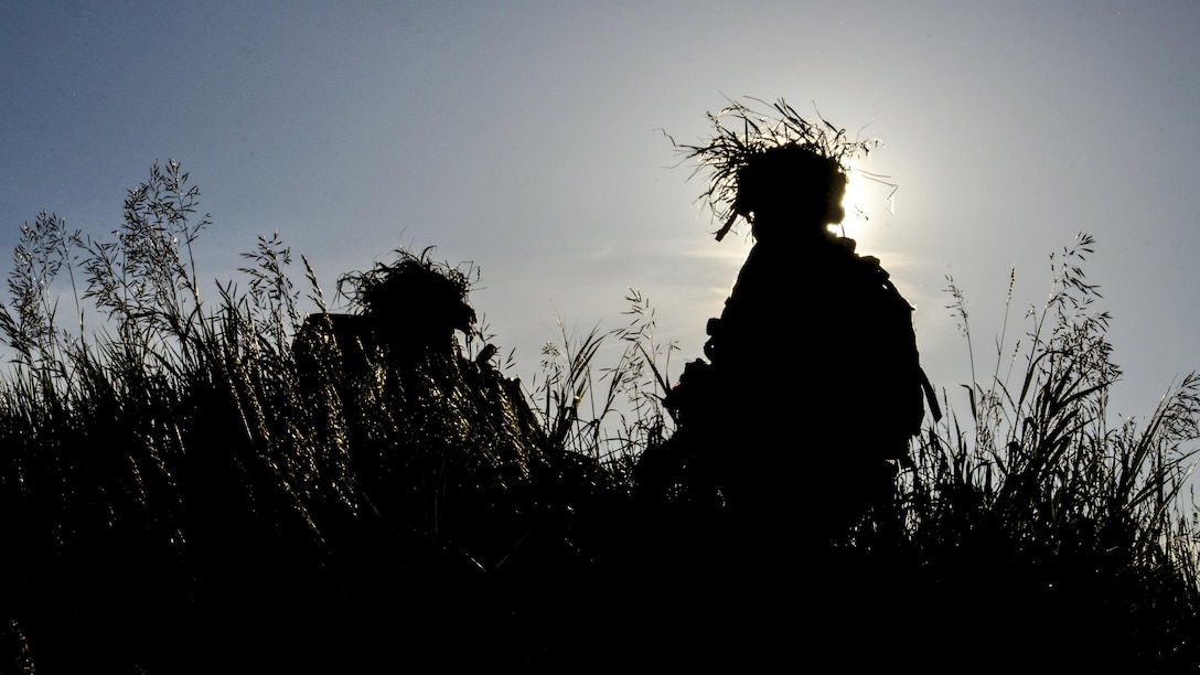 Camouflaged soldiers move to high ground to search for simulated enemy threats as part of the Saber Strike 17 multinational field training exercise in Bemowo Piskie, Poland, June 14, 2017. Saber Strike is an annual U.S. Army Europe-led multinational combined forces exercise. Army photo by Sgt. Justin Geiger