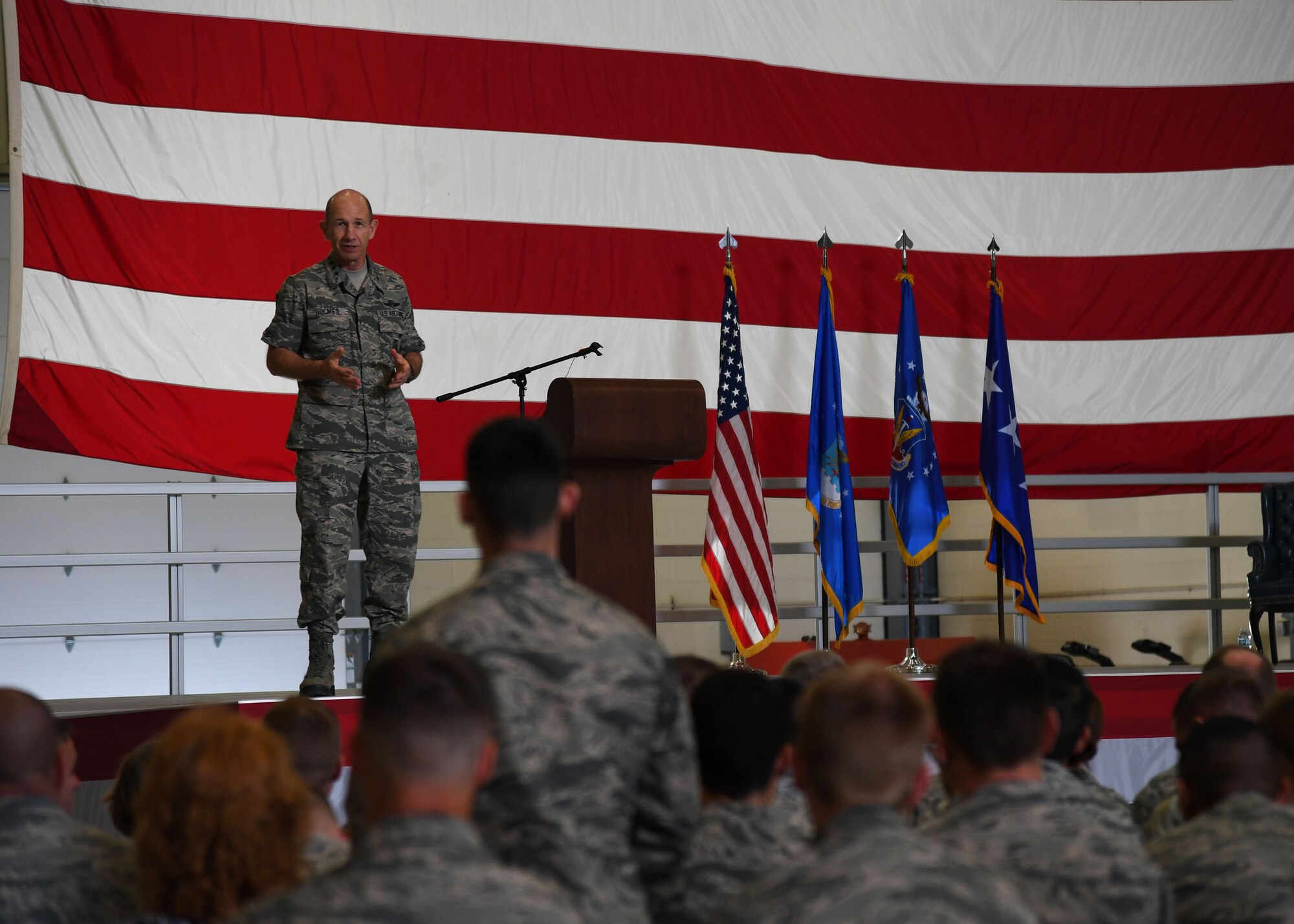 Gen. Mike Holmes, Air Combat commander, responds to a question asked by an officer in the audience during an all-call at Grand Forks Air Force Base, N.D., June 15, 2017. Holmes opened up the floor during the all-call, allowing Airmen to ask questions about the recent transition of the 319th Air Base wing from Air Mobility Command, to Air Combat Command. (U.S. Air Force photo by Airman 1st Class Elora McCutcheon)