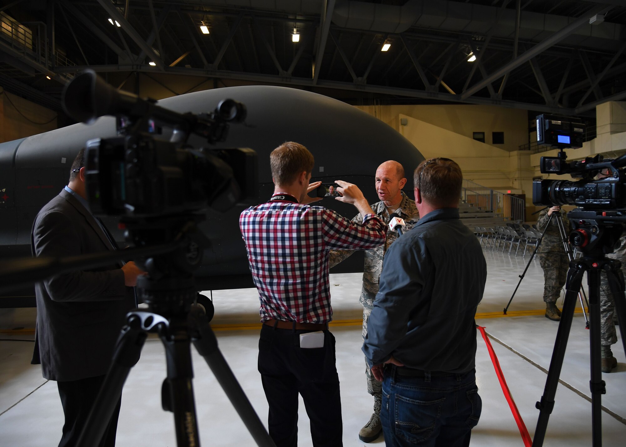 Gen. Mike Holmes, Air Combat Control commander, speaks during an interview with a local news channel, WDAZ News, after a realignment ceremony at Grand Forks Air Force Base, N.D., June 15, 2017. The ceremony marked the first official day of the 319th Air Base Wing’s transition from Air Mobility Command to Air Combat Command. (U.S. Air Force photo by Airman 1st Class Elora McCutcheon)