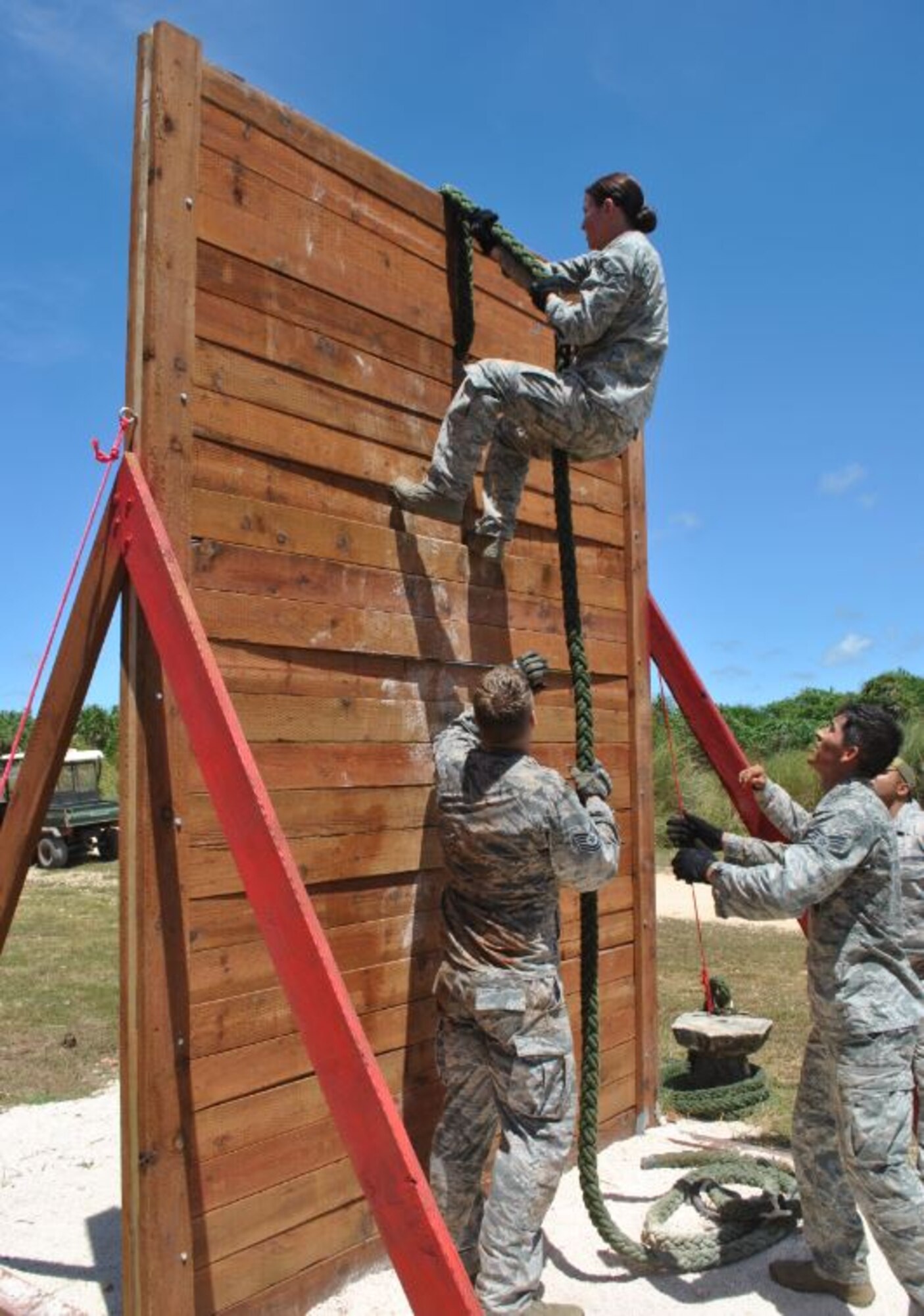Airman 1st Class Kimberly Burton, 374 SFS patrolman, climbs over an obstacle during the mental and physical challenge of the 2017 Security Forces Advanced Combat Skills Assessment June 9, 2017, at Andersen Air Force Base, Guam. The Yokota Air Force Base team won first place in the MAPs Challenge out of 11 Pacific Air Force bases to compete. (Curtesy photo by Capt. Kevin D. Collett) 