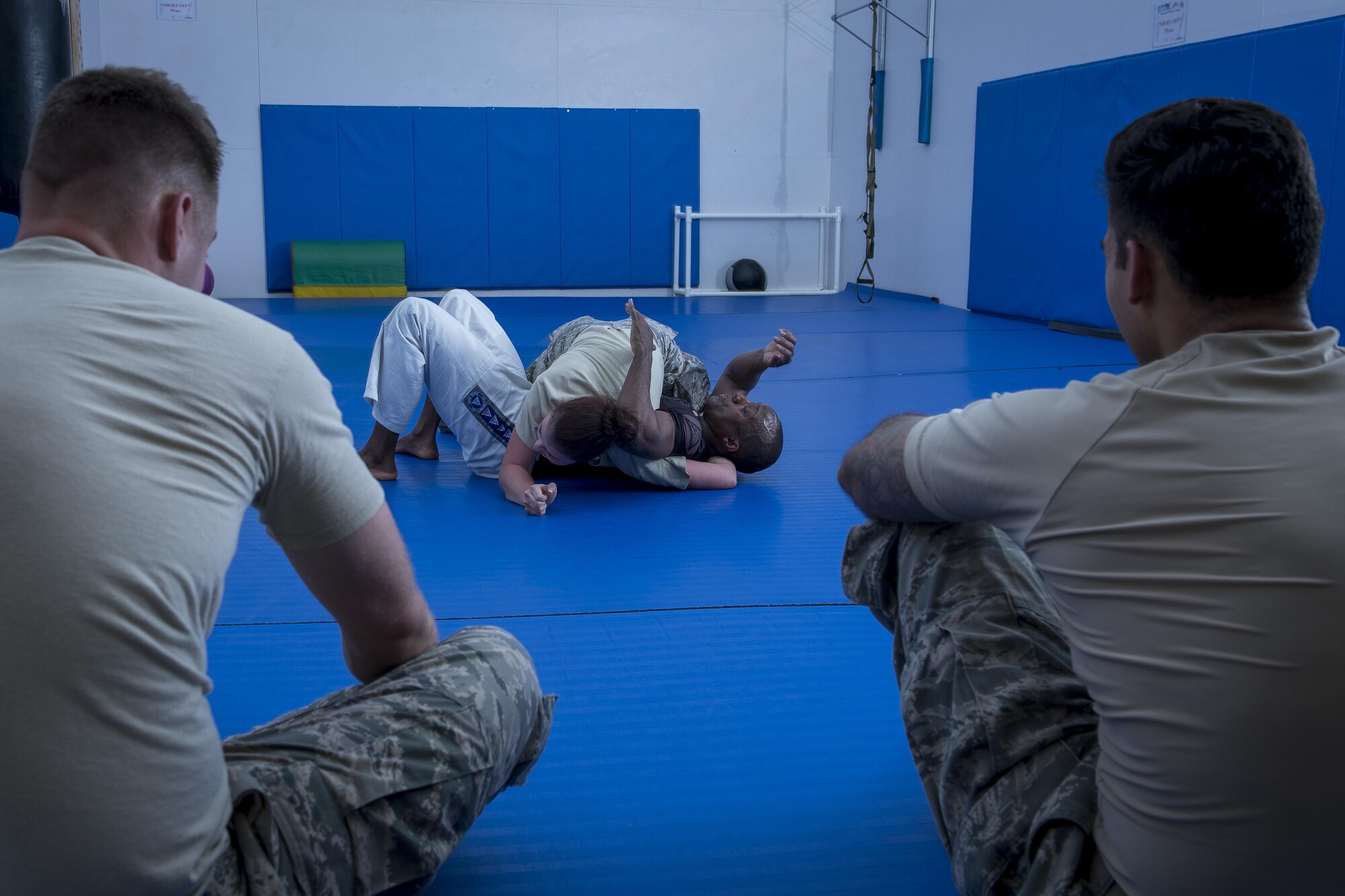 Maj. Tyrone Bess, combatives and Jiu-Jitsu instructor, demonstrates disadvantaged position combative techniques with Airman 1st Class Kimberly Burton, 374th Security Forces Squadron patrolman, May 11, 2017, at Yokota Air Base, Japan. In preparation for the 2017 Security Forces Advanced Combat Skills Assessment competition at Andersen Air Force Base, Guam, the 374 SFS team regularly trained in combatives with Bess. (U.S. Air Force photo by Airman 1st Class Donald Hudson)