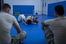 Maj. Tyrone Bess, combatives and Jiu-Jitsu instructor, demonstrates disadvantaged position combative techniques with Airman 1st Class Kimberly Burton, 374th Security Forces Squadron patrolman, May 11, 2017, at Yokota Air Base, Japan. In preparation for the 2017 Security Forces Advanced Combat Skills Assessment competition at Andersen Air Force Base, Guam, the 374 SFS team regularly trained in combatives with Bess. (U.S. Air Force photo by Airman 1st Class Donald Hudson)