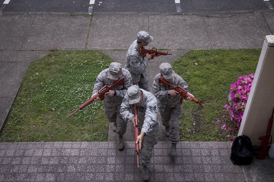 374th Security Forces Squadron members enter a building in formation during close quarters combat training, May 15, 2017, at Yokota Air Base, Japan. The 374 SFS team regularly trained in close quarter combat tactics for the 2017 Security Forces Advanced Combat Skills Assessment competition at Andersen Air Force Base, Guam in which they placed second. (U.S. Air Force photo by Airman 1st Class Donald Hudson)