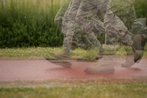 The 374th Security Forces Squadron Advanced Combat Skills Assessment team runs at Samurai Training Grounds while in full uniform during physical training, May 25, 2017, at Yokota Air Base, Japan. The 2017 Security Forces ACSA competition includes a physical training portion where the teams must complete the Combat Fitness Test as a team. (U.S. Air Force photo by Airman 1st Class Donald Hudson)