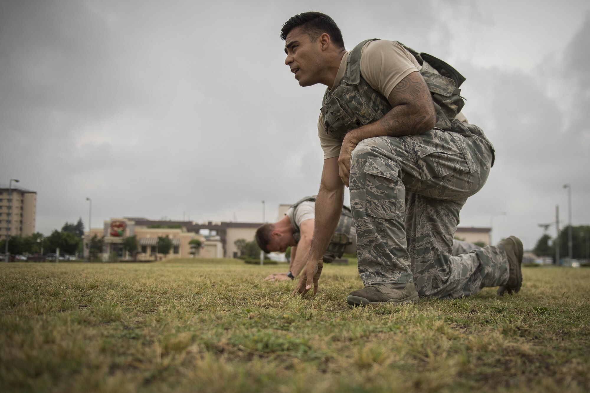 Staff Sgt. Oscar Gomez, 374th Security Forces Squadron non-commissioned officer in charge of plans and programs, gets up to sprint after completing pushups during physical training, May 25, 2017, at Yokota Air Base, Japan. Gomez was part of the 2011 winning team of the Global Strike Challenge and won best firing team at the 2012 GSC; he acted as the 374 SFS team coach for the 2017 Security Forces Advanced Combat Skills Assessment completion. (U.S. Air Force photo by Airman 1st Class Donald Hudson)