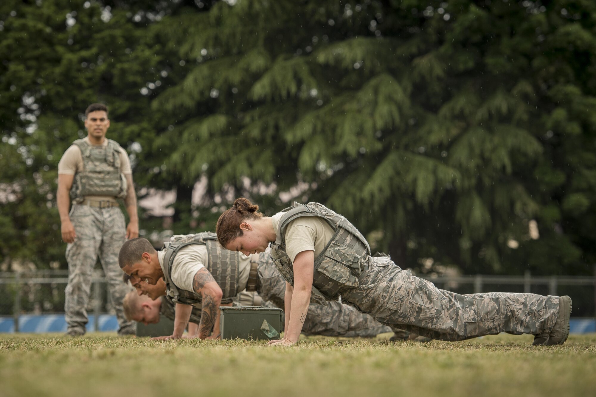 The 374th Security Forces Squadron 2017 Security Forces Advanced Combat Skills Assessment team performs pushups during physical training, May 25, 2017, at Yokota Air Base, Japan. The 374 SFS team regularly trained in full uniform, running a mile and completing the core tasks of the Combat Fitness Test a total of four times in one physical training session in preparation for the ACSA competition at Andersen Air Force Base, Guam. (U.S. Air Force photo by Airman 1st Class Donald Hudson) 