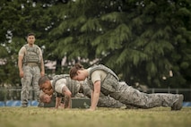 The 374th Security Forces Squadron 2017 Security Forces Advanced Combat Skills Assessment team performs pushups during physical training, May 25, 2017, at Yokota Air Base, Japan. The 374 SFS team regularly trained in full uniform, running a mile and completing the core tasks of the Combat Fitness Test a total of four times in one physical training session in preparation for the ACSA competition at Andersen Air Force Base, Guam. (U.S. Air Force photo by Airman 1st Class Donald Hudson) 