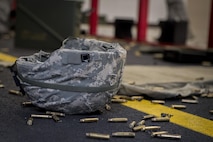 A helmet lays on the ground surrounded by shell casings, May 25, 2017, at Yokota Air Base, Japan. The 374 SFS 2017 Security Forces Advanced Combat Skills Assessment team regularly practiced firing various weapons including the M4 carbine assault rifle, M9 pistol, M249 light machine gun and the M203 grenade launcher in preparation for the Advanced Combat Skills Assessment competition at Andersen Air Force Base, Guam. (U.S. Air Force photo by Airman 1st Class Donald Hudson)