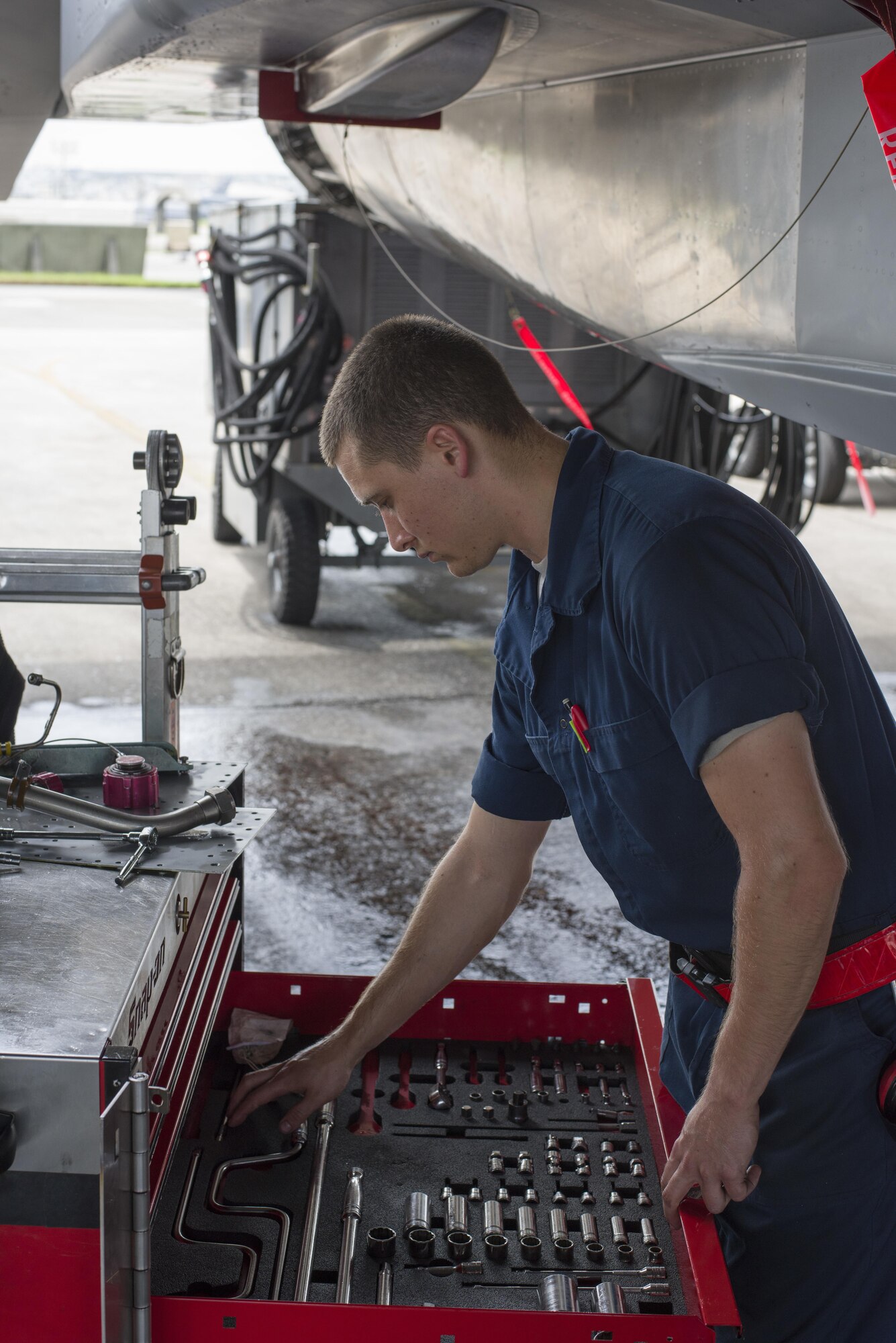 U.S. Air Force Airman 1st Class Andrew Tarnutzer, 67th Aircraft Maintenance Unit F-15 Eagle assistant dedicated crew chief, retrieves tools during maintenance June 13, 2017, at Kadena Air Base, Japan. The 67th AMU maintains the aircraft of one of the largest fighter wings in the U.S. Air Force. (U.S. Air Force photo by Senior Airman Omari Bernard)
