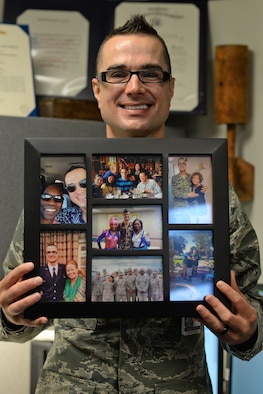 U.S. Air Force Capt. Jason Gordon, 36th Medical Operation Squadron mental health specialist and Andersen Air Force Base Pride Month coordinator, holds up a picture frame featuring his husband, his family and his time in the Navy June 15, 2017, at Andersen AFB, Guam. Gordon joined the armed forces when the Don’t Ask, Don’t Tell act was still enforced and got to see the change in the military after it was repealed. Gordon coordinated events to recognize Pride Month such as a color run, a paint and sip evening and a mixer and informational booth at the Freedom Fest scheduled for the end of the month. (U.S. Air Force photo by Senior Airman Alexa Ann Henderson)