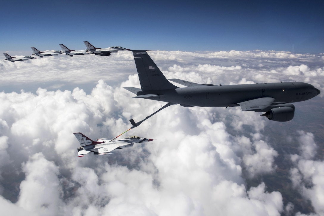 A KC-135 Stratotanker aircraft, right, fuels an F-16 Fighting Falcon assigned to the Thunderbirds, while the Thunderbirds fly to Nellis Air Force Base, Nev., June 12, 2017. The Thunderbirds, the Air Force’s air demonstration squadron, are based at Nellis. Air Force photo by Tech. Sgt. Christopher Boitz