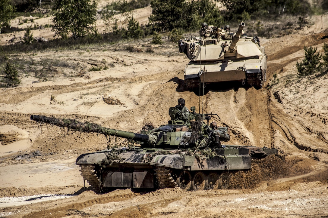 Polish soldiers and U.S. Marines operate tanks during a combined arms live-fire training event at the Adazi training grounds in Latvia, June 9, 2017, as part of Saber Strike, an annual exercise in the Baltic region and Poland. Marine Corps photo by 1st Lt. Kristine Racicot