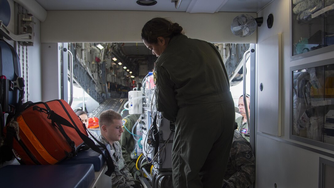 U.S. Air Force Maj. Margaret Dodd, a 18th Medical Operations Squadron neonatal intensive care unit nurse from Kadena Air Base, Japan, assists in lifting Oliver McKeown, son of Capt. Connor McKeown, during an aeromedical evacuation in Aomori, Japan, June 15, 2017. The coordination process also had to filter through the Aomori Airport Management Office, Theater Patient Movement Requirements Center, which builds the evacuation mission, source the aircraft and assign the aircrew and medical team. (U.S. Air Force photo by Senior Airman Deana Heitzman)