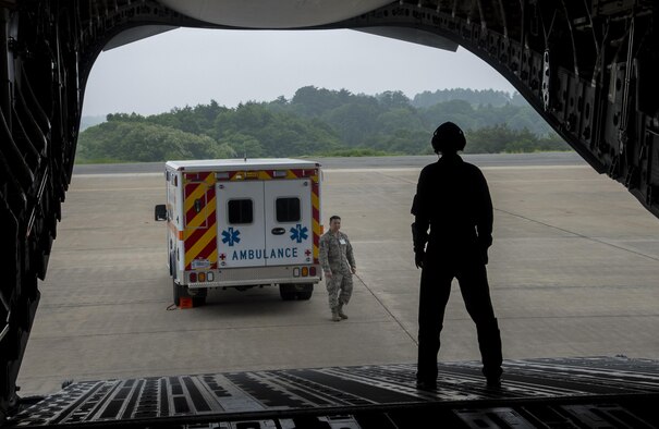 An Airman assigned to the 18th Medical Group from Kadena Air Base, Japan, assists with an aeromedical evacuation in Aomori, Japan, June 15, 2017. Since the Misawa Air Base runway remains closed for construction, the 35th Medical Group relied on solidified friendships among the Japanese community to help coordinate the evacuation at the Aomori Airport. (U.S. Air Force photo by Senior Airman Deana Heitzman)