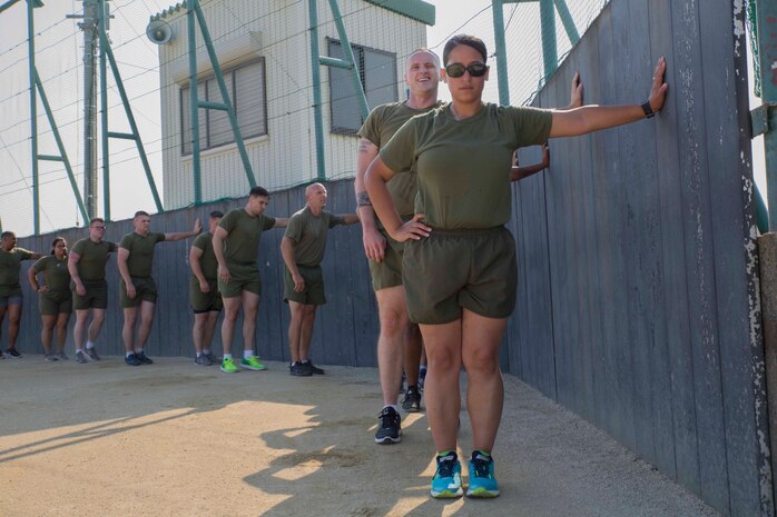U.S. Marines wait for instruction during a Fitness Road Show at Marine Corps Air Station Iwakuni, Japan, June 14, 2017. Instructors with Force Fitness Division from Quantico, Va. visited MCAS Iwakuni as part of the road show to critique force-fitness instructors’ coaching and course and to answer any questions the teachers and students had. Force Fitness Instruction is a course intended to help Marines improve their fitness. (U.S. Marine Corps photo by Lance Cpl. Gabriela Garcia-Herrera)