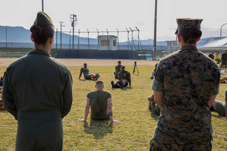 U.S. Marine Corps Staff Sgt. Charles London, lead force-fitness instructor for Marine Corps Air Station Iwakuni, shows his Marines how to foam roll their hamstring during a Fitness Road Show at MCAS Iwakuni, Japan, June 14, 2017. Instructors with Force Fitness Division from Quantico, Va. visited MCAS Iwakuni as part of the road show to critique force-fitness instructors’ coaching and to answer any questions the teachers and students had. Force Fitness Instruction is a course intended to help Marines improve their fitness. (U.S. Marine Corps photo by Lance Cpl. Gabriela Garcia-Herrera)