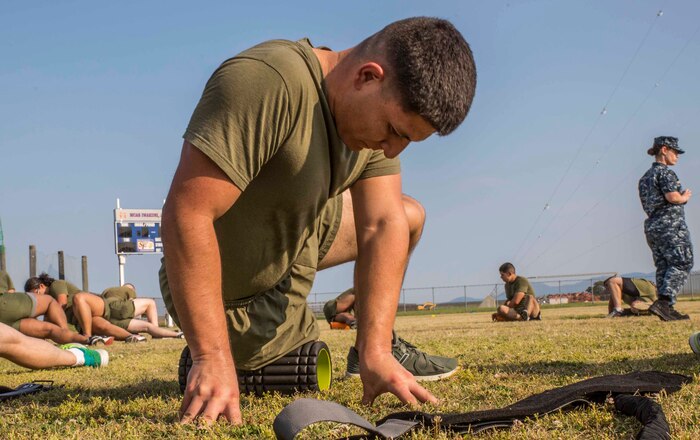 U.S. Marine Corps Lance Cpl. Daniel Ruiz, a flight equipment technician with Marine Aviation Logistics Squadron (MALS) 12, rolls out his iliotibial band during a Fitness Road Show at Marine Corps Air Station Iwakuni, Japan, June 14, 2017. Instructors with Force Fitness Division from Quantico, Va. visited MCAS Iwakuni during a Fitness Road Show to critique force-fitness instructors’ coaching and course and to answer any questions the teachers and students had. Force Fitness Instruction is a course intended to help Marines improve their fitness. (U.S. Marine Corps photo by Lance Cpl. Gabriela Garcia-Herrera)