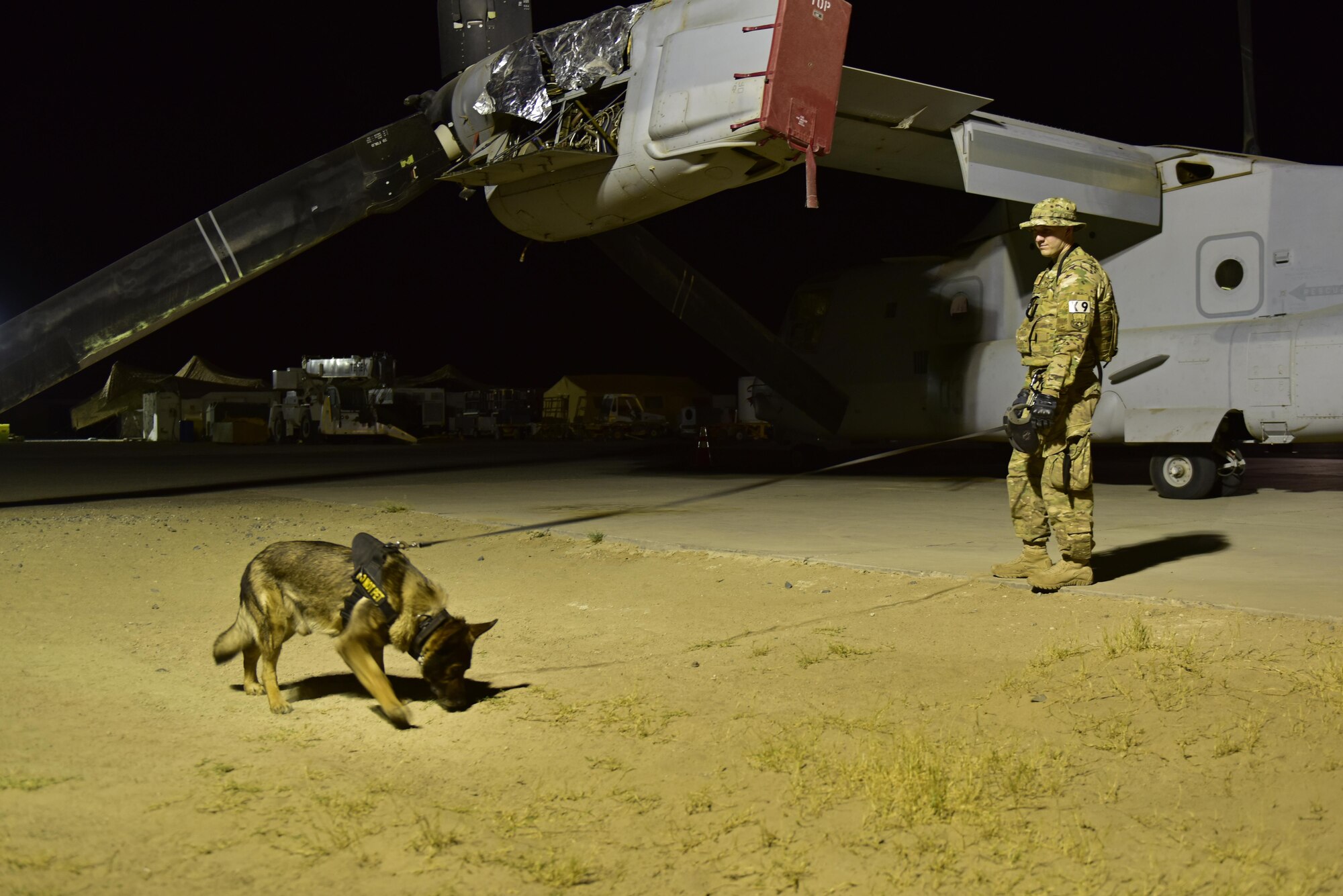 Senior Airman Carlton Isaacson, 407th Expeditionary Security Forces military working dog handler,and Egon, 407th ESFS military working dog, conduct a flightline perimeter walk May 23, 2017, at the 407th Air Expeditionary Group in Southwest Asia. Isaacson and Egon have been partnered for approximately a year and a half. (U.S. Air Force photo by Senior Airman Ramon A. Adelan)