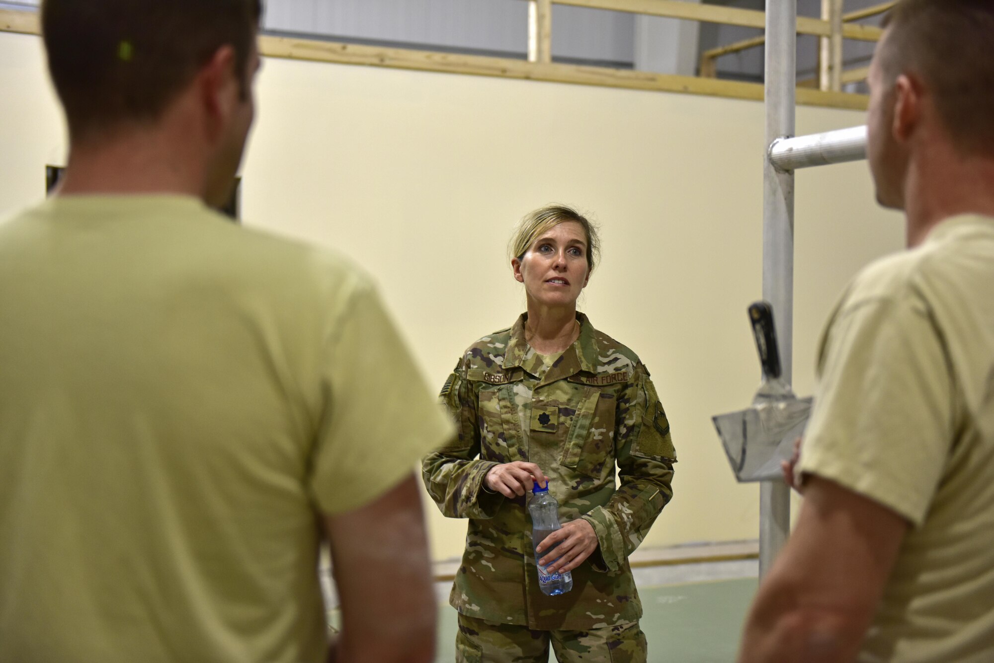 Lt. Col Heidi Gibson (middle), 407th Expeditionary Civil Engineer Squadron commander, discusses the progression of a construction project with Tech. Sgt. Mark Ricketts, 407th ECES structures assistant NCO in charge, and Staff Sgt. Troy Schneider, structural craftsman, June 7, 2017, at the 407th Air Expeditionary Group in Southwest Asia. Gibson administers to more than 260 Total Force Airmen. Their objectives are to sustain the base infrastructure and to initiate actions for future contingencies.(U.S. Air force photo by Senior Airman Ramon A. Adelan)