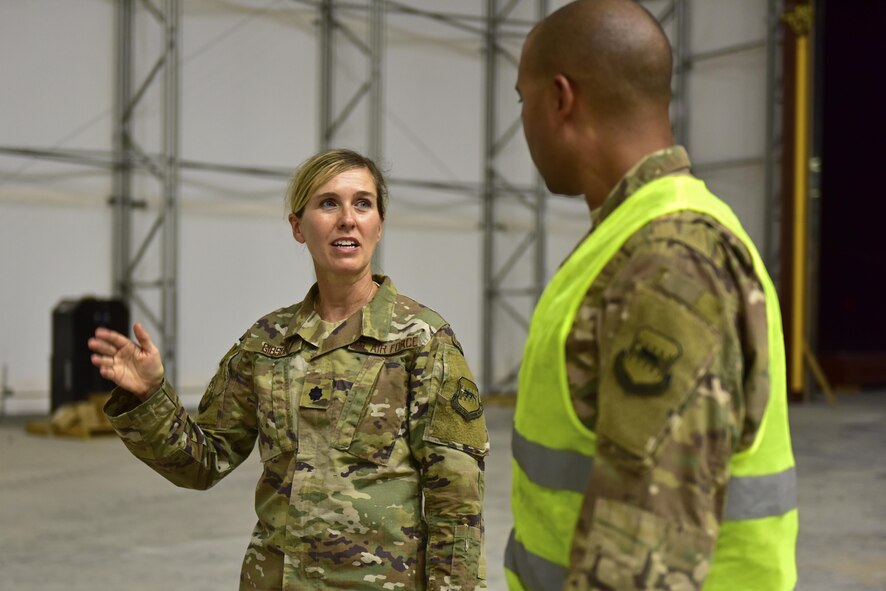 Lt. Col. Heidi Gibson, 407th Expeditionary Civil Engineer Squadron commander, speaks to Senior Master Sgt. Malcom Summers, 407th ECES heavy repair superintendent, about the current progress of a construction project June 7, 2017, at the 407th Air Expeditionary Group in Southwest Asia. Gibson administers to more than 260 Total Force Airmen. Their objectives are to sustain the base infrastructure and to initiate actions for future contingencies.(U.S. Air force photo by Senior Airman Ramon A. Adelan)