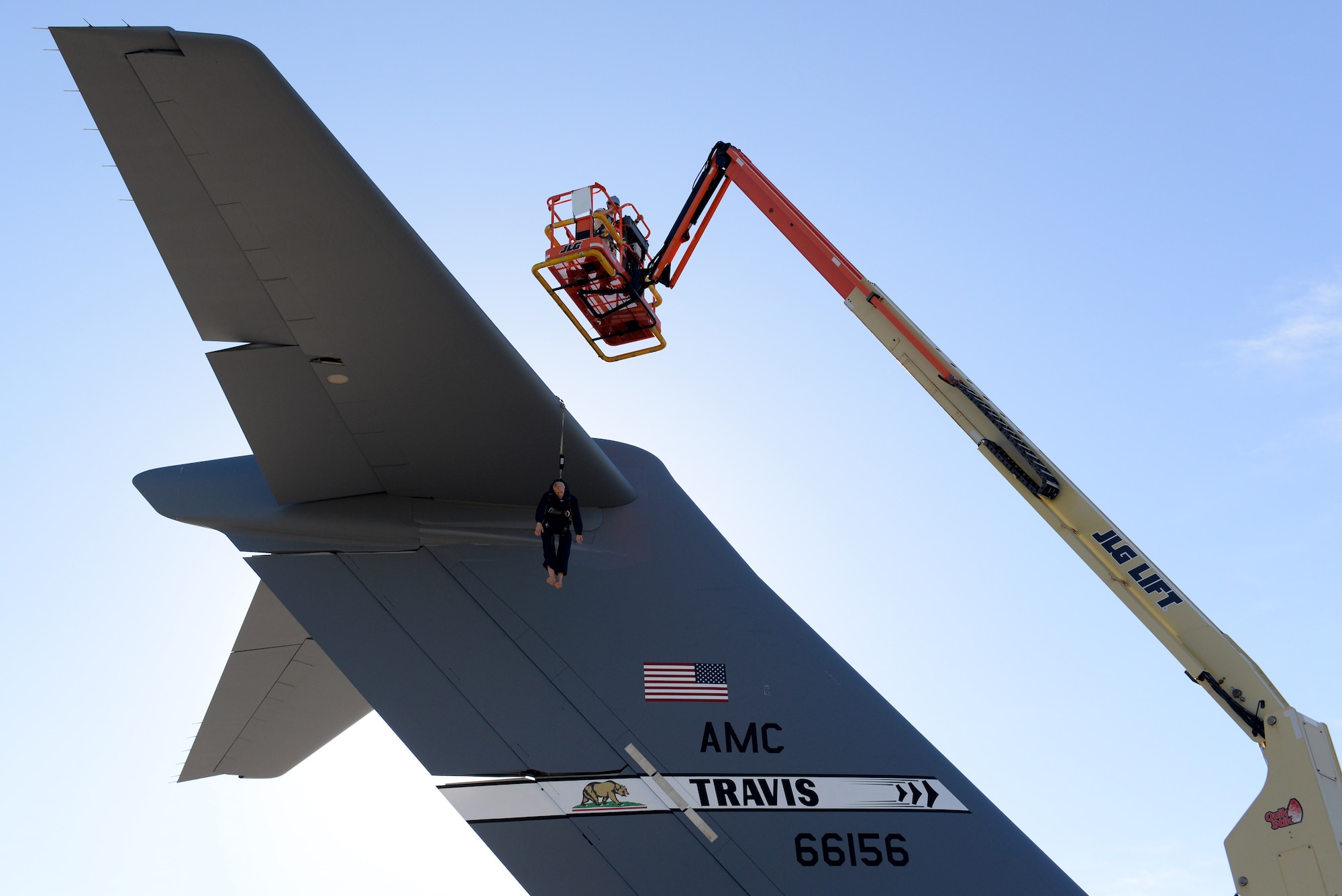 U.S. Air Force Tech. Sgt. Brandon Crilley, 734th Air Mobility Squadron navigation and communication specialist, retrieves a training dummy during a training exercise June 12, 2017, at Andersen Air Force Base, Guam. The exercise allowed the Airmen of the 734th AMS to practice fall rescue procedures from the top of a C-17 Globemaster III tail 55 feet in the air. (U.S. Air Force photo by Airman 1st Class Gerald R. Willis)