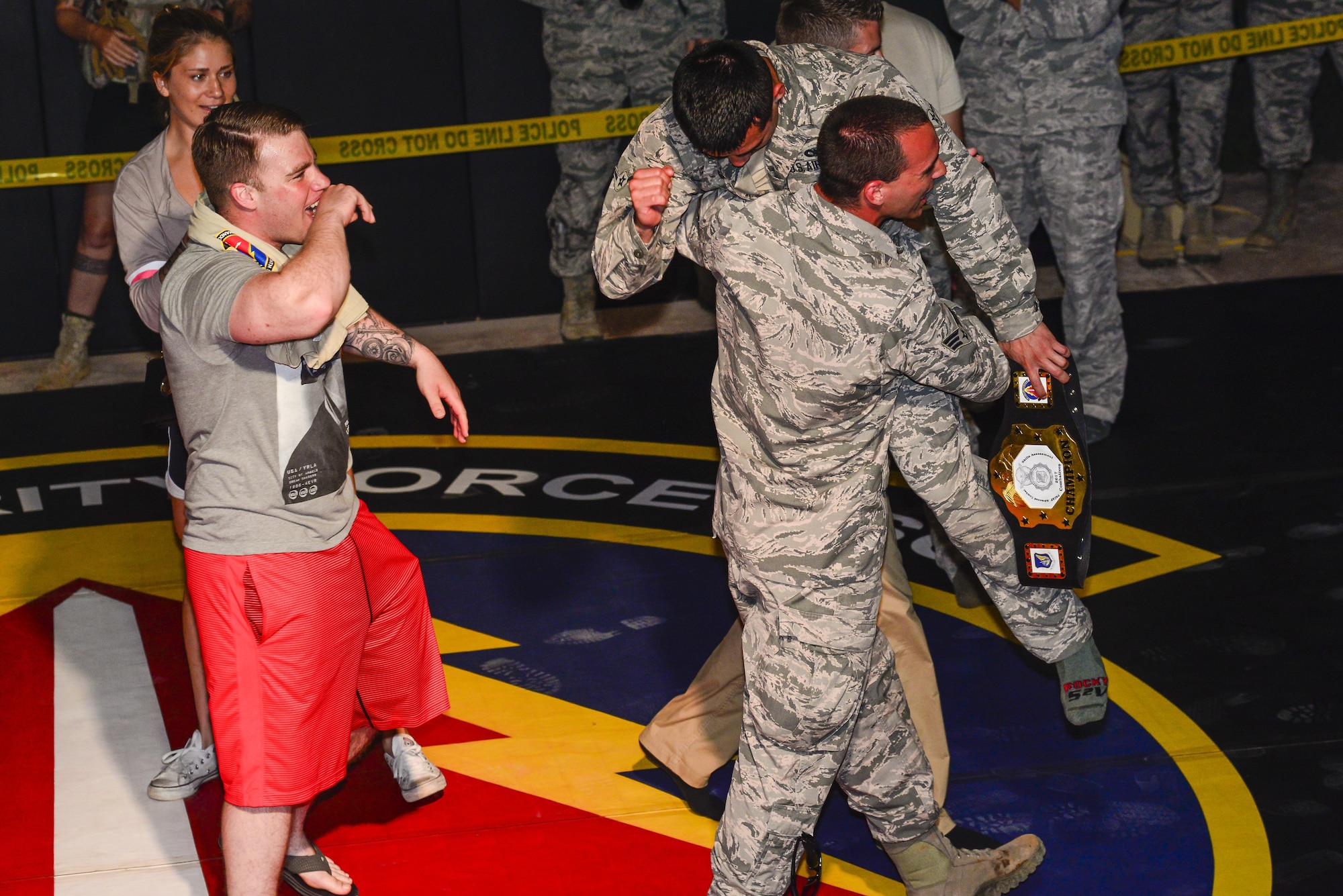 Members from the 35th Security Forces Squadron congratulate Airman Sergio Miranda, a 35th SFS entry controller, after winning the belt and title of the 2017 Combatives Champion during the second annual Security Forces Advanced Combat Skills Assessment held at the Security Forces Regional Training Center at Andersen Air Force Base, Guam, June 8, 2017. More than 100 Airmen and Soldiers throughout the U.S. Pacific Command’s area of responsibility gathered to compete in five different categories: weapons, tactics, combat fitness, mental and physical challenge and military working dog handling. (U.S. Air Force photo by Airman 1st Class Christopher Quail)