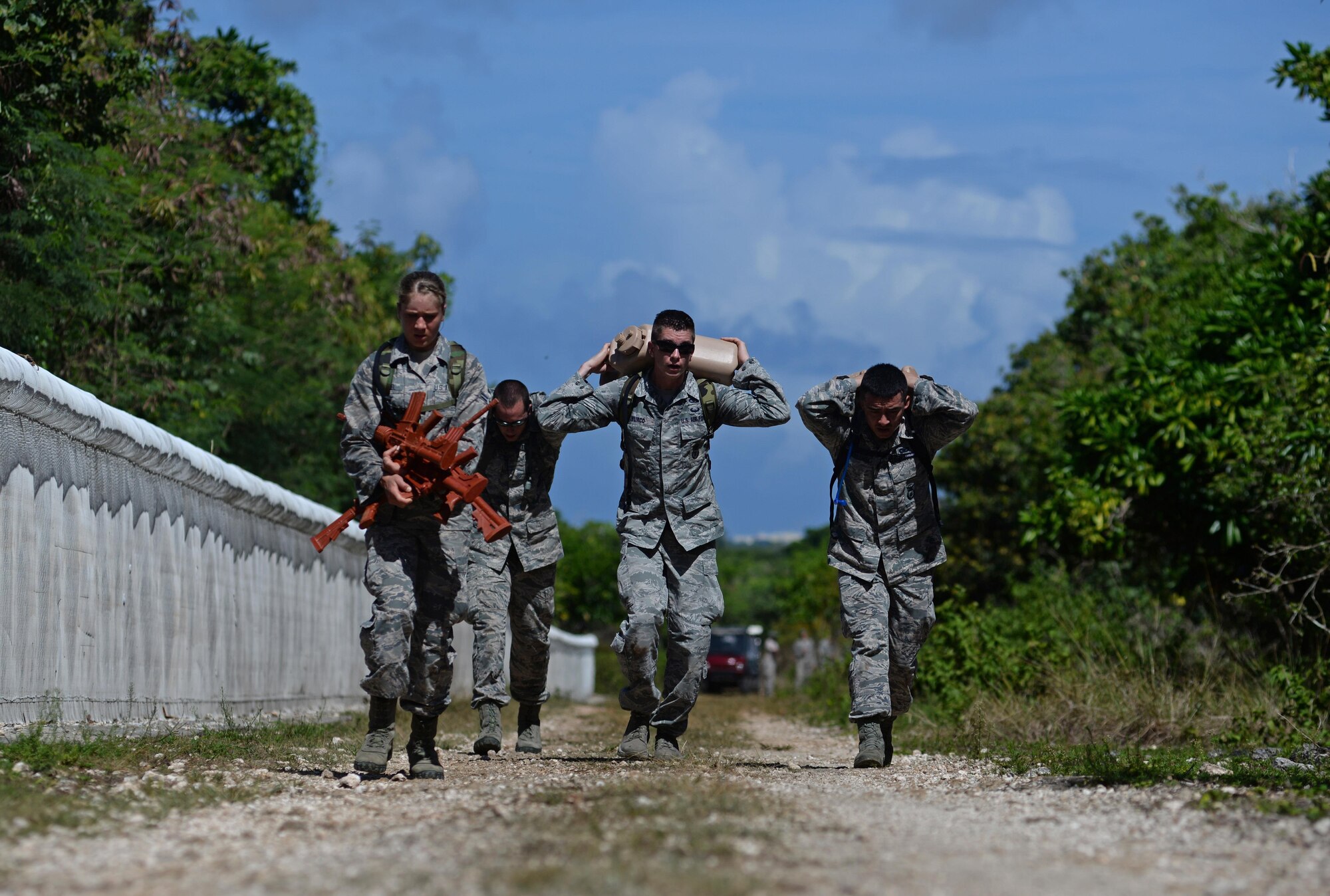 Members from the 35th Security Forces Squadron carry miscellaneous items during the second annual Security Forces Advanced Combat Skills Assessment held at the Security Forces Regional Training Center at Andersen Air Force Base, Guam, June 6, 2017. More than 100 Airmen and Soldiers throughout the U.S. Pacific Command competed in five categories including weapons, tactics, combat fitness, a mental and physical challenge and military working dogs. Each station conducted evaluations based on time to determine the best marksmen and combat tactics teams in the Pacific Air Forces security forces. The 35th SFS are the advanced Combat Skills champions. (U.S. Air Force photo by Airman 1st Class Gerald R. Willis)