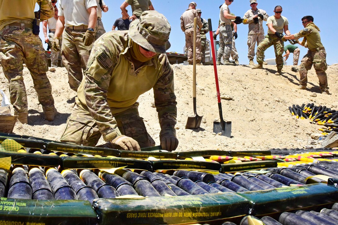 Air Force Staff Sgt. Devin Stuart places explosives on top of munitions during an explosive ordnance disposal operation in Southwest Asia, June 6, 2017. Stuart is an explosive ordnance disposal technician assigned to the 407th Expeditionary Civil Engineer Squadron. Air Force photo by Senior Airman Ramon A. Adelan