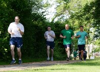 Staff Sgt. Jordan Swaner, 66th Medical Squadron radiology technician, leads others, including Col. Roman L. Hund, installation commander, during a safety-themed fun run June 14. The run was hosted by the 66th Air Base Group Safety Office in recognition of National Safety Month. (U.S. Air Force photo by Linda LaBonte Britt)