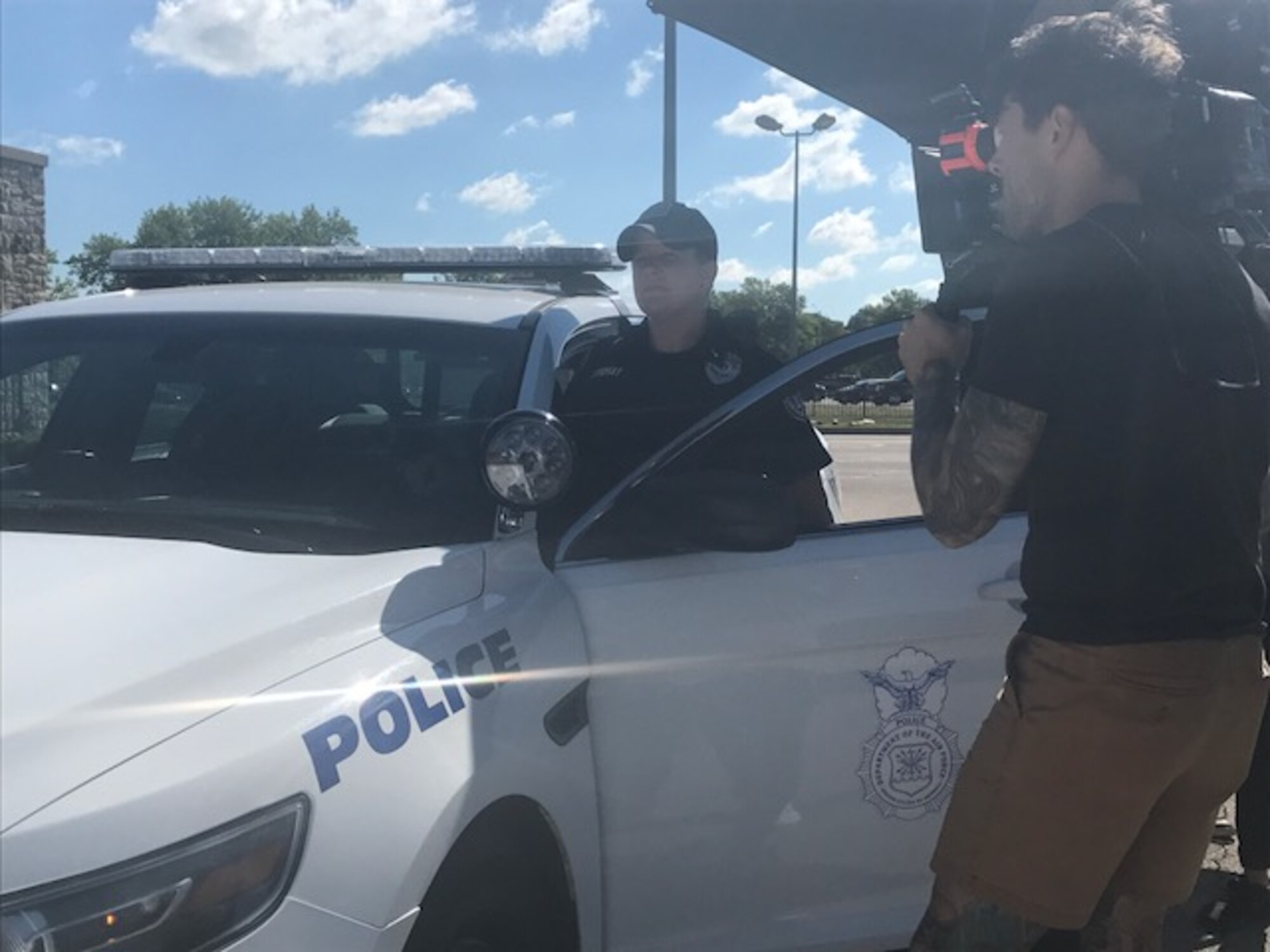 Stephanie Cordray, 88th Security Forces Squadron police officer, is filmed exiting a police vehicle for the PACE’s “Teamwork” Heritage Today video on June 6, 2017. Cordray and Ragan Weaver (not pictured) were selected to represent civilians in Security Forces and the contributions they make to the Air Force mission. (U.S. Air Force photo/Stacey Geiger)