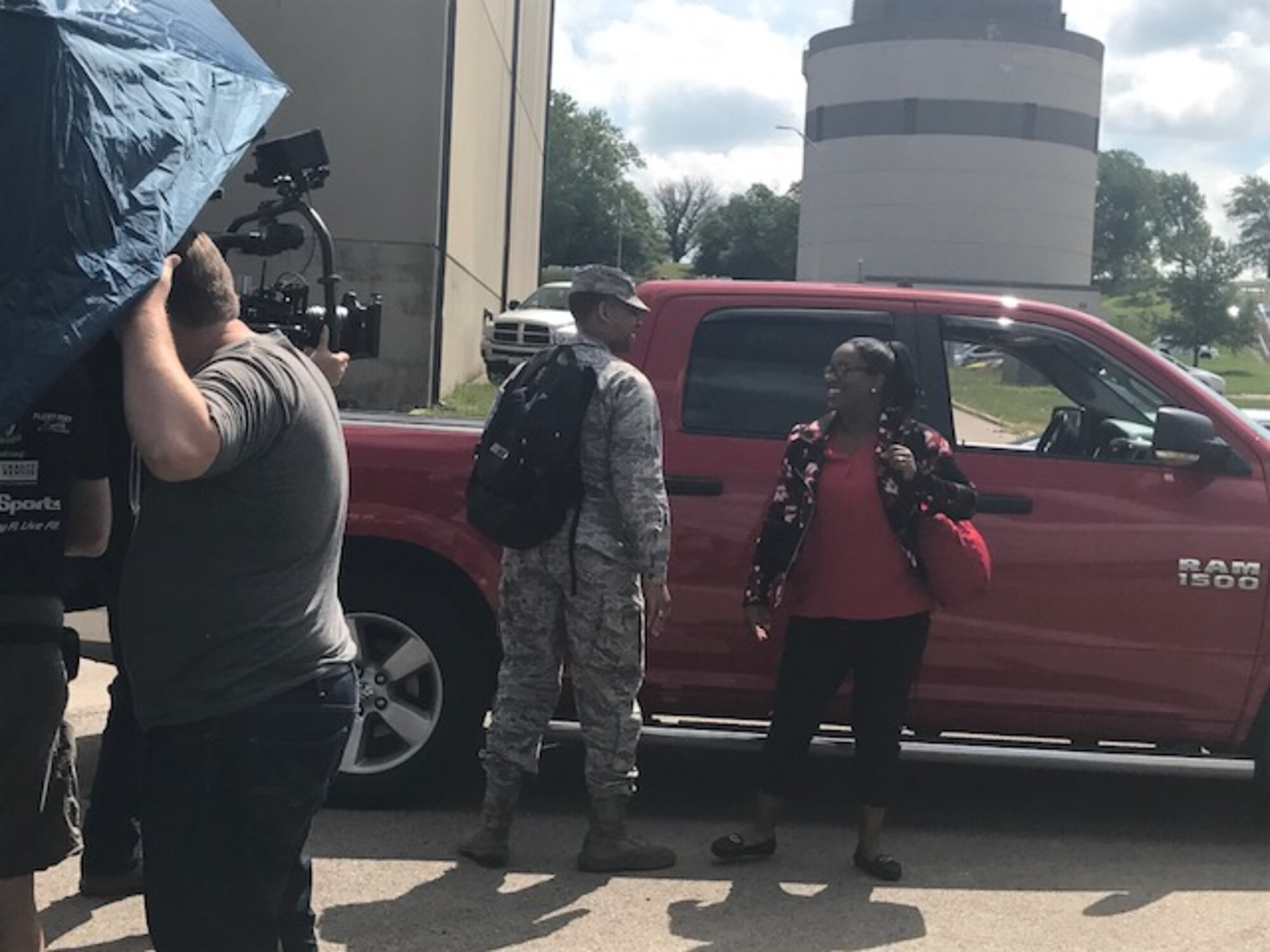 Jasmine Moore, 88th Force Support Squadron education and training Pathway intern, and husband Lt. Calvin Moore, Air Force Life Cycle Management Center program manager, film a scene arriving to work together for the PACE’s “Teamwork” Heritage Today video on June 8, 2017. The video will feature Air Force civilians and their contributions to the Air Force mission. (U.S. Air Force photo/Stacey Geiger)