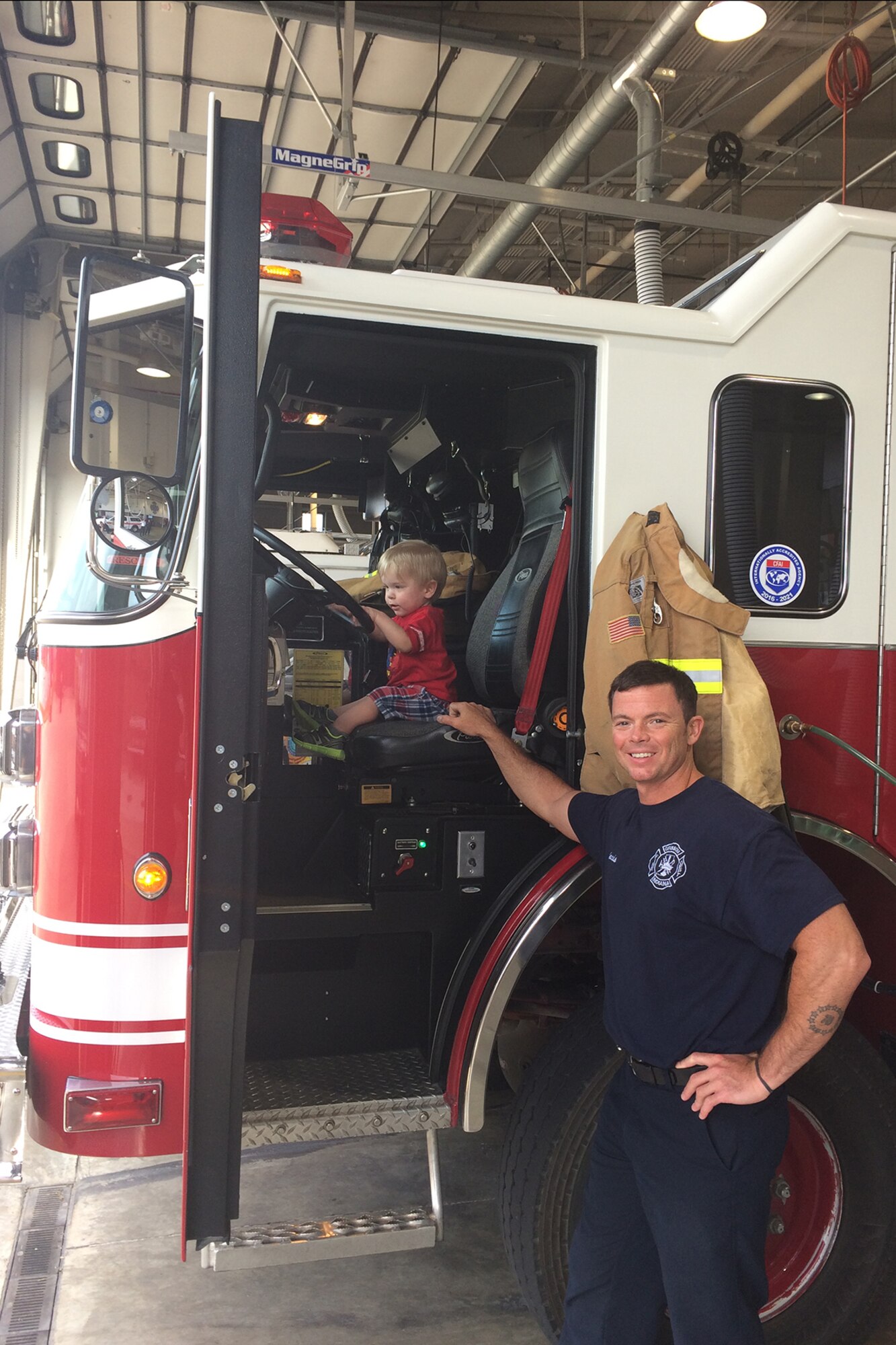 Robert Jacobs, Grissom fire fighter, poses with Waylon Shupperd,2, during the Shupperd family’s visit to the fire station, May 23. The department recently responded to a call for Waylon and ultimately helped save his life. (Courtesy photo)