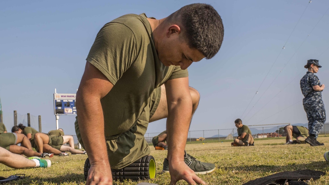 U.S. Marine Corps Lance Cpl. Daniel Ruiz, a flight equipment technician with Marine Aviation Logistics Squadron 12, rolls out his iliotibial band during a Fitness Road Show at Marine Corps Air Station Iwakuni, Japan, June 14, 2017. Instructors with Force Fitness Division from Marine Corps Base Quantico, Virginia visited MCAS Iwakuni during a Fitness Road Show to critique force-fitness instructors’ coaching and course and to answer any questions the teachers and students had. Force Fitness Instruction is a course intended to help Marines improve their fitness.