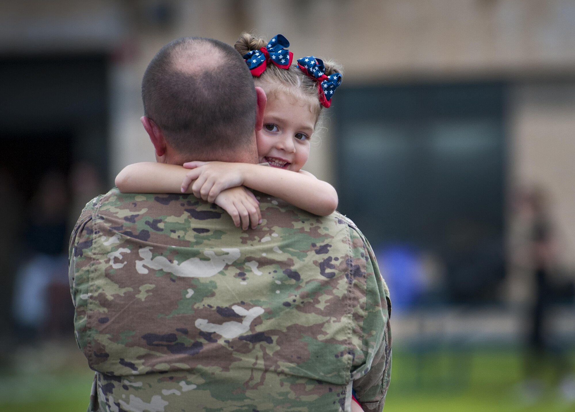 Staff Sgt. Matthew Pearson, a 71st Aircraft Maintenance Unit navigation specialist, holds his daughter, Savannah, during a redeployment, June 6, 2017, at Moody Air Force Base, Ga. The 41st and 71st Rescue Squadrons were recently deployed to Southwest Asia where they provided combat search and rescue capabilities in support of Operation Inherent Resolve. (U.S. Air Force photo/Airman 1st Class Lauren M. Sprunk)