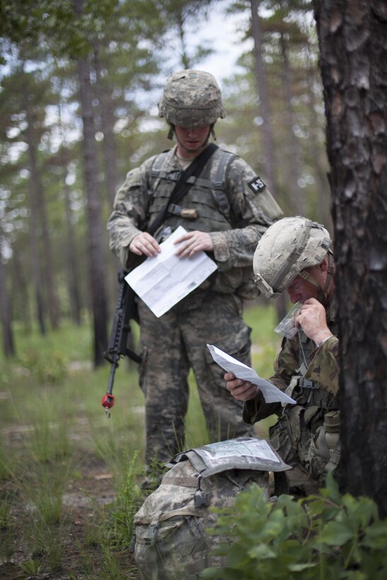 Sfc. Andrew England a combat engineer representing the 416th Theater Engineer Command, along with Ssg. David Rosa a psychological operations specialist representing the United States Army Civil Affairs and Psychological Operations Command (Airborne), stops to check grid coordinate during a mystery events, at the 2017 U.S. Army Reserve Best Warrior Competition at Fort Bragg, N.C. June 15. This year's Best Warrior Competition will determine the top noncommissioned officer and junior enlisted Soldier who will represent the U.S. Army Reserve in the Department of the Army Best Warrior Competition later this year at Fort A.P. Vill, Va. (U.S. Army Reserve photo by Spc. Jesse L. Artis Jr.) (Released)