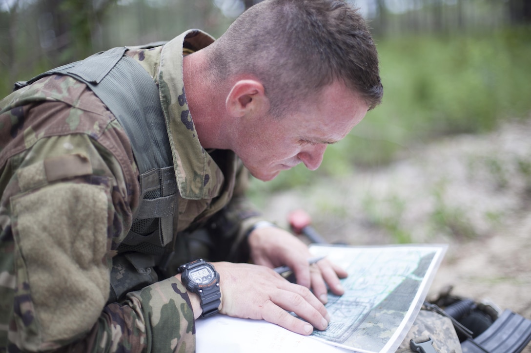 Sfc. Andrew England a combat engineer representing the 416th Theater Engineer Command, stops to plot grid coordinates during a mystery events, at the 2017 U.S. Army Reserve Best Warrior Competition at Fort Bragg, N.C. June 15. This year's Best Warrior Competition will determine the top noncommissioned officer and junior enlisted Soldier who will represent the U.S. Army Reserve in the Department of the Army Best Warrior Competition later this year at Fort A.P. Vill, Va. (U.S. Army Reserve photo by Spc. Jesse L. Artis Jr.) (Released)