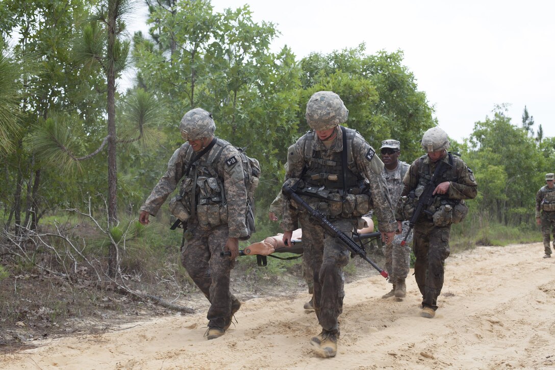 Four Warriors carry a simulated casualty during a mystery event at the 2017 U.S. Army Reserve Best Warrior Competition at Fort Bragg, N.C. June 15. This year's Best Warrior Competition will determine the top noncommissioned officer and junior enlisted Soldier who will represent the U.S. Army Reserve in the Department of the Army Best Warrior Competition later this year at Fort A.P. Vill, Va. (U.S. Army Reserve photo by Spc. Jesse L. Artis Jr.) (Released)