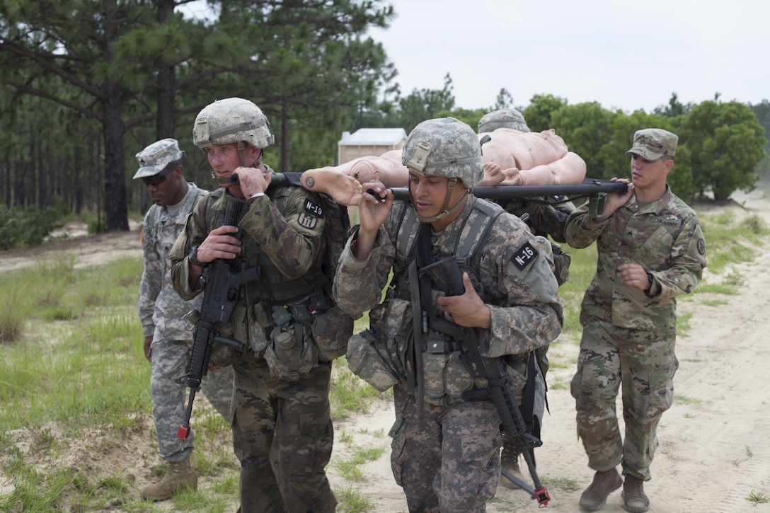 Four Warriors carry a simulated casualty during a mystery event at the 2017 U.S. Army Reserve Best Warrior Competition at Fort Bragg, N.C. June 15. This year's Best Warrior Competition will determine the top noncommissioned officer and junior enlisted Soldier who will represent the U.S. Army Reserve in the Department of the Army Best Warrior Competition later this year at Fort A.P. Vill, Va. (U.S. Army Reserve photo by Spc. Jesse L. Artis Jr.) (Released)