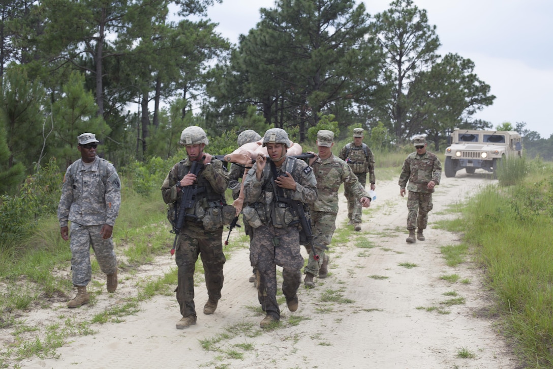 Four Warriors carry a simulated casualty during a mystery event at the 2017 U.S. Army Reserve Best Warrior Competition at Fort Bragg, N.C. June 15. This year's Best Warrior Competition will determine the top noncommissioned officer and junior enlisted Soldier who will represent the U.S. Army Reserve in the Department of the Army Best Warrior Competition later this year at Fort A.P. Vill, Va. (U.S. Army Reserve photo by Spc. Jesse L. Artis Jr.) (Released)